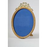 A 19th century gilt metal oval shaped picture frame, inset turquoise with ribbon finial, supplied by