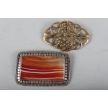 A gilt metal Celtic brooch and a white metal brooch inset banded agate