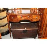 A late Georgian mahogany bowfront carving table, fitted one shallow and two deep drawers, on