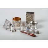A silver match box holder, a triangular-shaped napkin ring, two other silver napkin rings, a