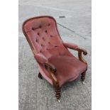 A Victorian mahogany showframe scroll armchair, button upholstered in a pink velour, on turned and