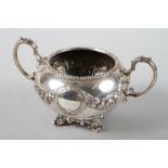 A Victorian silver sugar bowl with embossed floral swag decoration, 8 3/4" high, 14.1oz troy approx