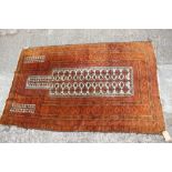 A gold wash Afghan prayer rug of traditional design with multiple borders in shades of gold, orange,