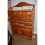 A waxed pine tile back bottle rack with drawers over cupboards, 48" wide x 20" deep x 60" high