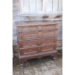 An early 18th century oak two-section chest on stand of four drawers with panelled fronts, 40" wide,