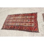 A Middle Eastern rug with five central geometric pattern lines and multi-bordered in shades of