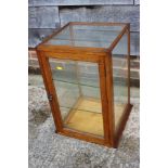 An oak framed table top display cabinet enclosed one door, 15" square x 24" high
