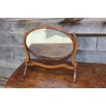A mahogany and oak oval skeleton back dressing table mirror, 20 1/2" wide, and a dressing stool,
