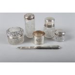 A silver teaspoon with engraved and pierced decoration, a silver topped scent bottle, three silver