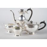 A silver four-piece tea and coffee service with ebonised knops and handles
