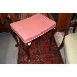 A rectangular dressing stool, upholstered in a pink fabric, on shell carved cabriole supports, an