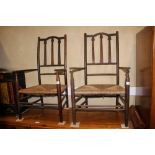 A pair of Arts & Crafts rush seat elbow chairs with triple splat backs