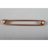 A 19th century yellow metal pin set two seed pearls, 4g