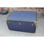 A travel trunk with brass mounts