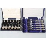 A cased set of six silver apostle spoons, a cased set of six silver handled cake forks and a pair of