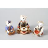 Three Royal Crown Derby bone china paperweights, seated bear with drum, 4 3/4" high, "Schoolboy