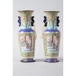 A pair of Chinese Canton enamel cloisonne vases with panels decorated figures on a floral pattern
