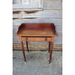A 19th century mahogany tray top washstand, fitted one drawer, on turned and castored supports,