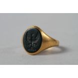 An 18ct gold signet ring with engraved bloodstone intaglio, size O, 6.9g overall
