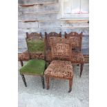 A set of four late 19th century carved walnut side chairs with padded seats and backs, on turned and