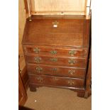 A late Georgian provincial oak fall front bureau, the interior fitted drawers and pigeonholes over
