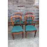 A set of four 19th century balloon back standard dining chairs with drop-in seats, on turned
