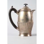 A silver hot water jug with half-fluted body and ebonised handle, 13.7oz troy approx