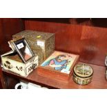 A brass box with embossed decoration, 6 1/4" high x 8 1/4" wide, a Chinese travelling vanity box