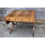 A George IV rosewood and satinwood banded sofa table, fitted two drawers, on panel end splay