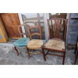 A late Georgian provincial oak framed side chair with splat back rush seat and one other rush