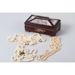 A cultured pearl necklace with 9ct gold clasp, a matching bracelet and two other pearl necklaces