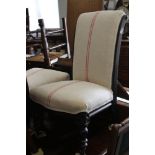 A pair of late 19th century ebonised low seat occasional chairs, upholstered in a red striped linen,