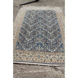 A Persian Nain rug, finely woven with all-over floral design on a blue ground and multi-bordered