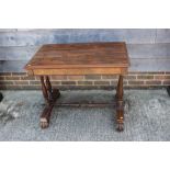 An early Victorian rosewood centre table, fitted one drawer, on twin turned columns and scroll
