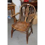 A late 19th century fruitwood, beech and elm panel seat Windsor wheelback elbow chair