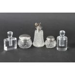 Two silver topped dressing table jars, two white metal topped scent bottles and a similar