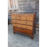 A late 18th century provincial oak and mahogany banded chest of two short and three long graduated