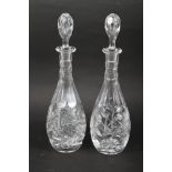 A pair of cut glass decanters and stoppers, 16" high
