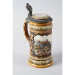 A Gottingen Mettlach beer stein, decorated landscape panel and metal mounts, 9" high overall