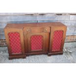 A late 19th century mahogany break serpentine front sideboard, fitted centre drawer and three