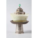 A Chinese ceremonial white metal cup, cover and stand with jade bowl, 7" high