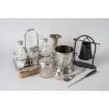 A cut glass six-bottle cruet with silver plated mounts and stand, a plated trumpet vase, a syphon