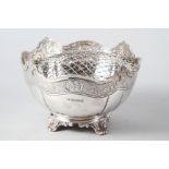 A silver rosebowl with engraved border and scrolled feet, 31.1oz troy approx