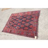 A Hamadan type rug with all-over gul design on a blue ground and broad floral border, 66" x 45"