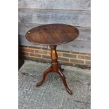 A 19th century mahogany circular tilt top table, on baluster turned column and tripod splay