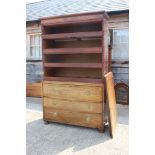 A 19th century figured mahogany linen press, the upper section fitted pull-out trays enclosed two