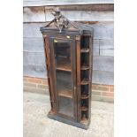A late 19th century walnut corner cabinet, fitted shelves enclosed glazed panel door with seated