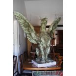 J M Boekbinder: a patinated plaster and composition seated griffin, 64" wide x 55" high