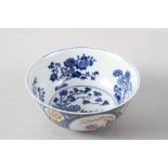 A Chinese famille rose bowl, decorated panels with various flowers on a blue textured glazed ground,