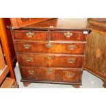 An early 18th century figured walnut and inlaid chest of two short and three long drawers, on